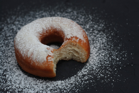 Tasty bitten donuts with icing and chocolateの写真素材