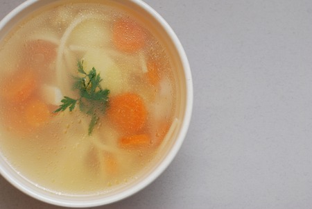 Bowl of chicken soup with vegetables andの写真素材