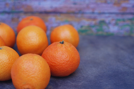 Vibrant Orange Tangerines on Dark Blue Background. Christmas New Year Greeting Card Poster Banner Template. Copy Space for Textの写真素材