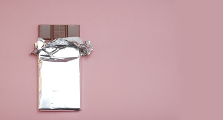 Top View of Chocolate Bar on Pinkの写真素材