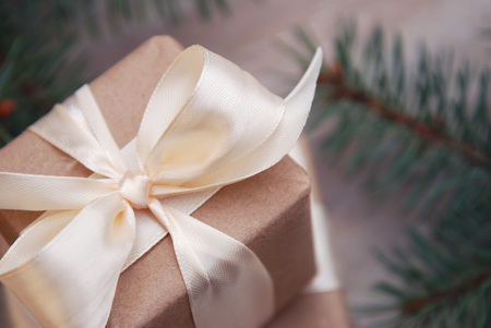 Christmas gift box Close Up with fir branches and cones on wooden background, copy space. Decorated Christmas gift.の写真素材