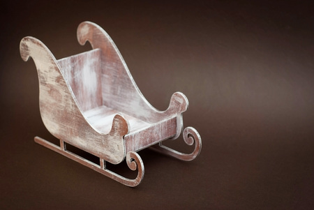 Wooden Decorative sledge isolated on Brown backgroundの写真素材