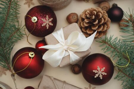Red Christmas Balls and Gift Boxes background. Fir Branches, Pinecones. Flat Lie. top View.の写真素材