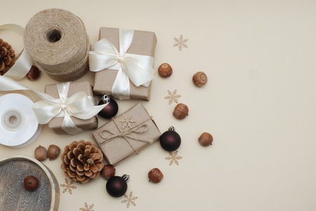Christmas Gift boxes Rustic Style, and Eco Decorations on a old wooden background. Pine cones, Nuts. Copy Space. top View.の写真素材