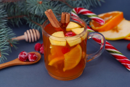 Hot Winter Fruit Tea in a Glass Cup , Cinnamon Stick, Orange and Tangerine, and Fir branch.の写真素材