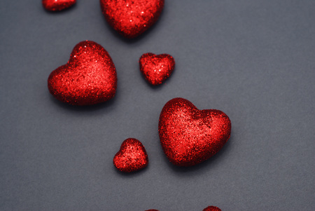 Happy Valentine Day Festive Sparkle Red Hearts. Glitter Red Hearts on Gray Background. Glitter Love confetti.の写真素材