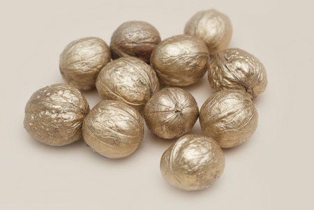 Golden Walnut Isolated. Cristmas Decoration on Warm Neutral Background.の写真素材