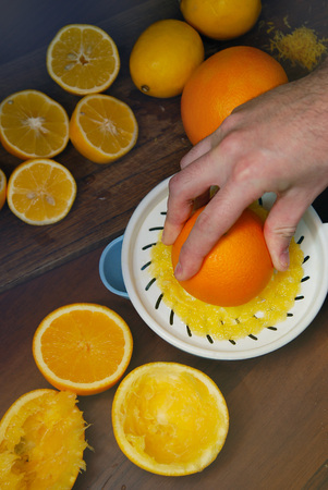 Closeup on men making orange juice. Recipe of Food. Vertical Image.の写真素材