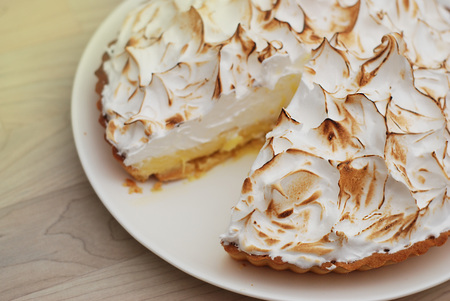Lemon Meringue Pie on White Plate. Woodenの写真素材