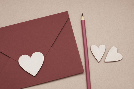 Vintage Red Envelope or letter, Wooden Heart with Pencil for Valentines Day in retro toning.