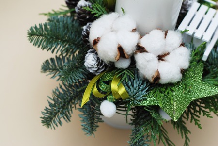 Christmas arrangement of fir branches, Cotton Flowers, Candle, Decorative Star, Ribbons, Copy Space, Neutral Background.の写真素材