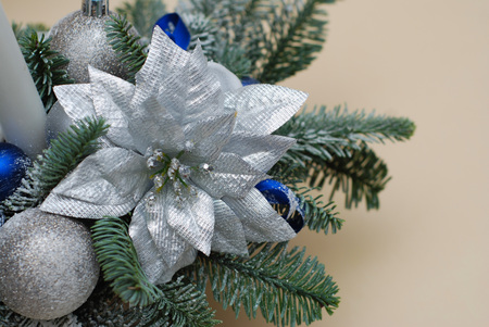 Decorative Christmas Arrangement with Pine Fir Branches, Big Silver Flower and Baubble, Globes and Blue Ribbons.の写真素材