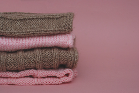 Brown and Pink Winter Knitted scarves. Scarf isolated on Pink background. Scarfs with copz Paste Space. Beauty. Fashion. Woof. Cloth. Fabric.の写真素材