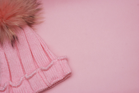 Cute knitted girl winter Pink hat isolated on Pink backgroundの写真素材