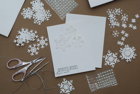 Making Christmas Greeting Card with Snowflakes. Handmade decorating with Paper Snowflakes with Beads on Brown Background.の写真素材