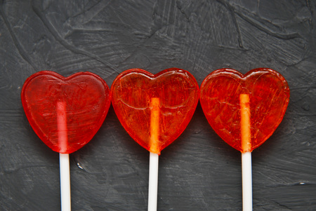 Colorful lollipops Heart Shape on dark background. Top view. Love and Valentines Day Concept.の写真素材