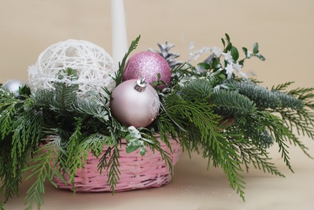 Christmas table centerpiece with pink and green ornaments, toned. New year greeting background with shiny balls.の写真素材