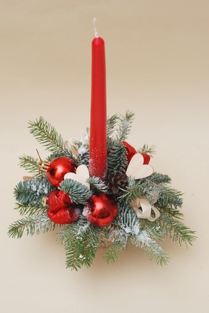 New Years composition. Red candle on spruce branches with fir cones. Christmas. Verticla image.の写真素材