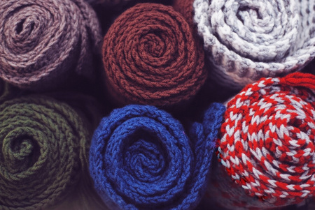 A neat pile of rolled knitted warmの写真素材