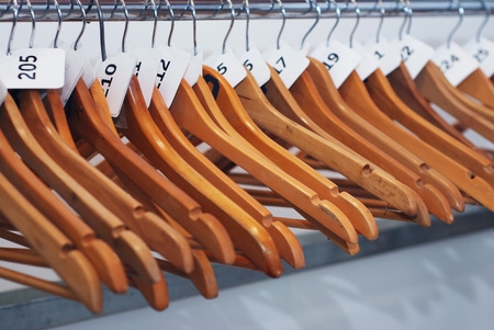 Close up of wooden cloth hangers in row on white backgroundの写真素材