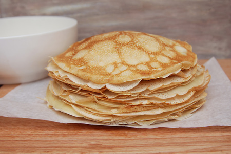 Delicious pancakes traditional for Russian pancake week on wooden board. close up.の写真素材