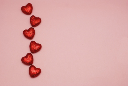 Valentines Day background, red sparkle hearts, top view against pink background with copy spaceの写真素材