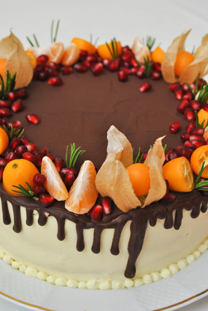 Delicious white Cake with fresh fruits, citrus and pomegranate on the table. top view vertical.の写真素材