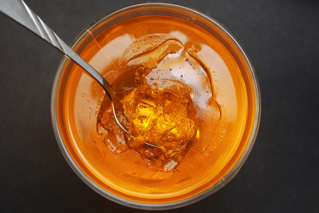 A glass of Orange Jellye with spoon on black background. Citrus jelly. Top View.の写真素材