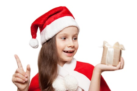 A 7 ears old Little Girl with Christmas Gift thinkig of What Santa Bring to Her. Isolated.の写真素材