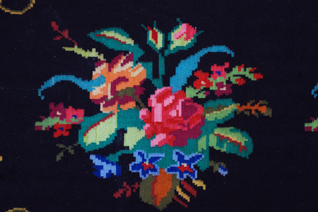 Close up Beautiful Rustic Traditional Carpet with Red Roses Ornament on black background Home Textilesの写真素材