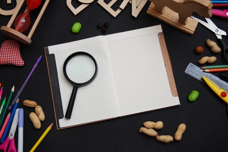 School Supplies on Blackboard Background with Open Notebook for Notes. Back to School Concept. Top view.の写真素材