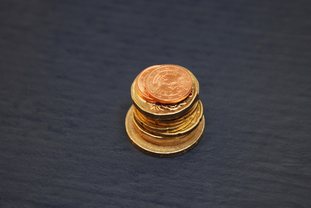 Personal saving, piles of gold coins on dollar bills, supplementary pension concept closeup selective focusの写真素材