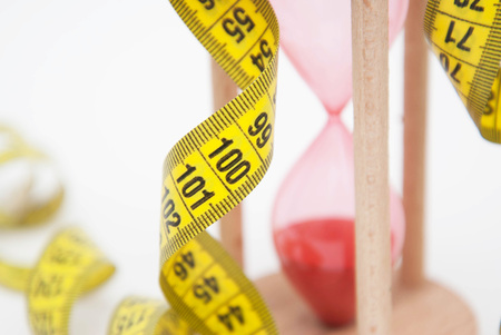 Diet and fitness Concept. Red  and Tape Measure close up. Fat Burning and Weight loss process.の写真素材