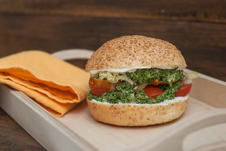 Hamburger homemade, in Wooden box, with fresh Tomatoe, Letuce, chicken meat, on rustic Wooden Background with copy Space.の写真素材