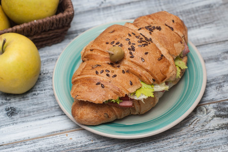 Croissant Sandwich with Tomatoes, Fresh Vegetables, Green Oliveの写真素材
