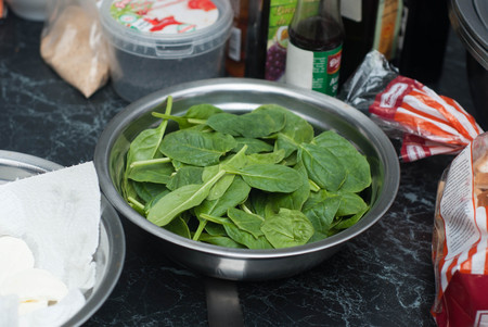 Spinach. Fresh Organic Spinach Leaves in metal Bowl on a wooden table.の写真素材