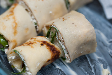 Pancakes Filled with Spinach and Cheesein Glass Bowl with Butter.の写真素材