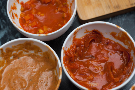 Three Kinds of Red Tomato Sauce in White Ceramic Bowls at the Restaurant Kitchenの写真素材