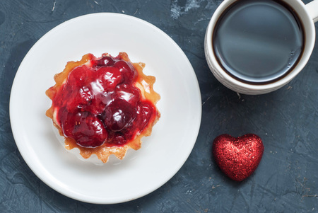 Valentine's Day Day Breakfast. Cup of Coffee, Fruit Tarttlet with Strawbberies, Red Glitter Heart.の写真素材