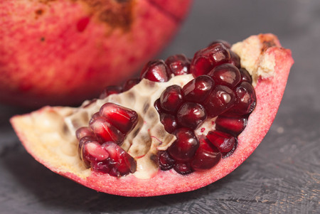 Close up Granate Seeds in slice. Pomegranate Slice Fruit. diet, vitamine and Health conceptの写真素材