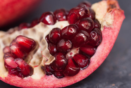 Slice of Pomegranate Fruit. Close up Granate Seedsの写真素材
