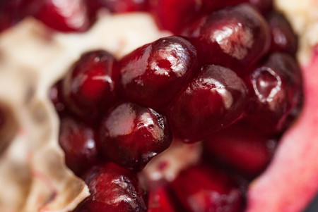 Macro of Fresh Peeled Ripe Seeds Pomegranate Isolated.