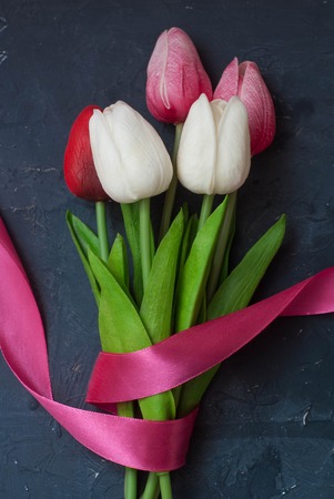 Beautiful Bouquet of Colorful Tulips on Dark Blue Background.の写真素材