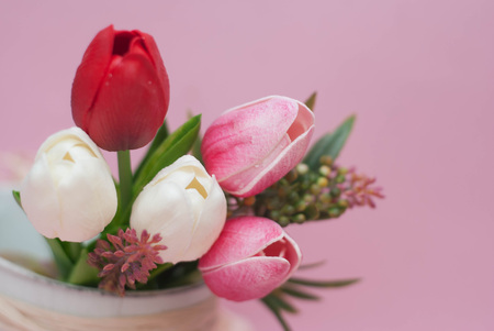 Bouquet of Red and White Fake Tulip Flower Bouquet on the Corner of Image.の写真素材