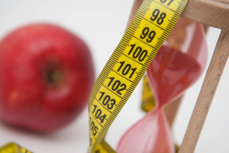 Red Apple and Tape Measure close up. Fat Burning and Weight loss process.の写真素材