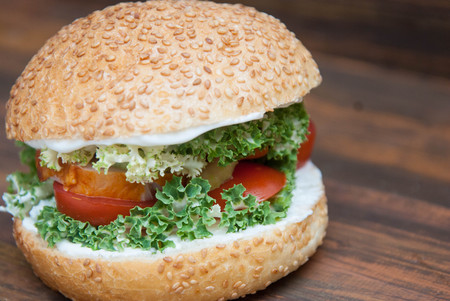 Homemade Hamburger with Fresh Letuce leaves, tomatoe Slice, Meat. Homemade Healthy Food or Fast food, with fresh Vegetables on rustic Wooden Backgroundの写真素材