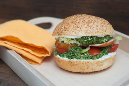 Fast Food. Homemade Hamburger in Wooden box, with fresh Vegetables on rustic Wooden Background with copy Space.の写真素材