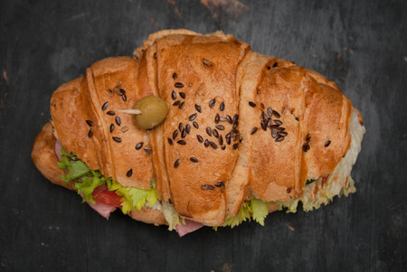 Top view of Croissant Sandwich with Vegetables and green Olive for Breakfast. Gray Textured Background. Healthy Homenade food.の写真素材