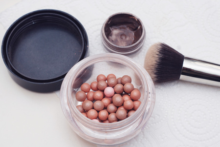 Pink blusher balls into container closeup imageの写真素材