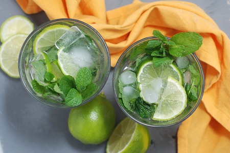 Mohito Alcohol Drink. Two Glasses with Cocktail Drinks and Ice cubesの写真素材